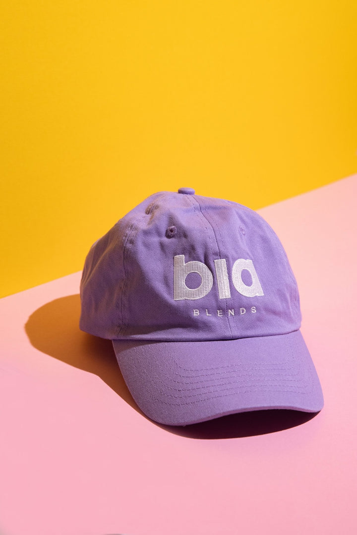 Purple cap with 'bia blends' text on a yellow and pink background