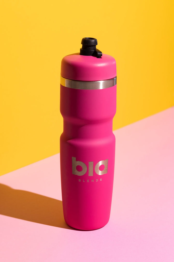 Pink water bottle with 'bia' branding on a yellow and pink background