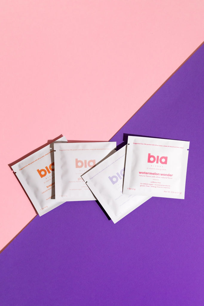 White packets with 'bia' branding on a pink and purple background